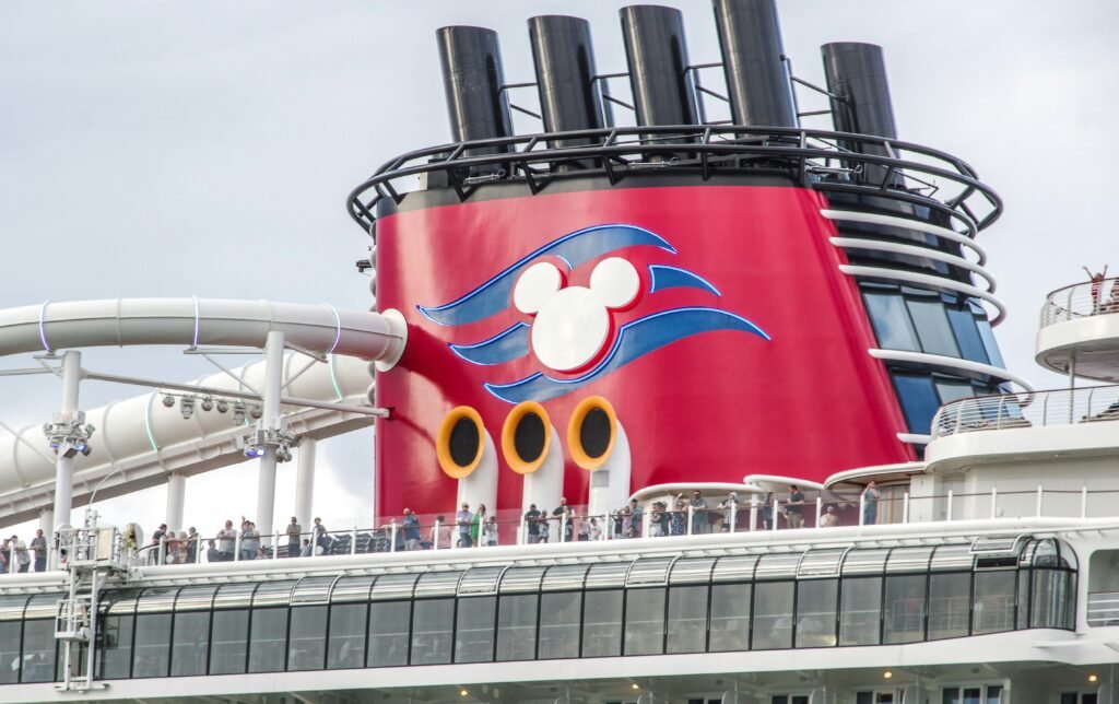 a large red and white boat with people on top of it a large red and white boat with people on top of it