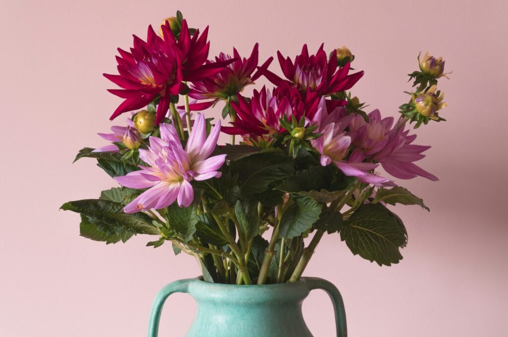 purple flowers in gray ceramic vase