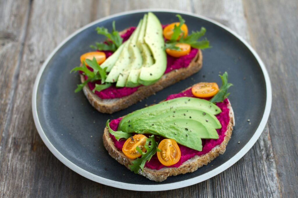 two sliced breads with avocado on top two sliced breads with avocado on top