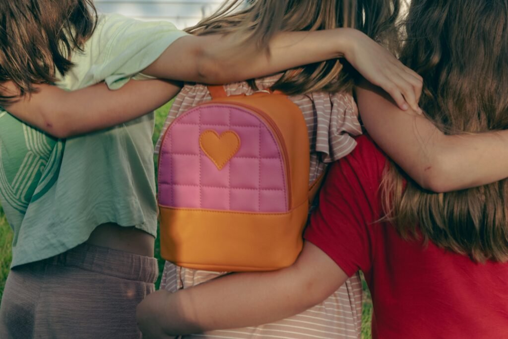 a group of young girls hugging each other a group of young girls hugging each other