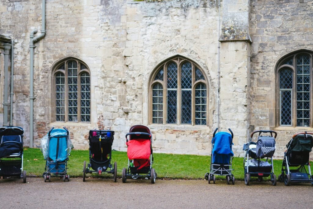 seven assorted-colored strollers near building seven assorted-colored strollers near building