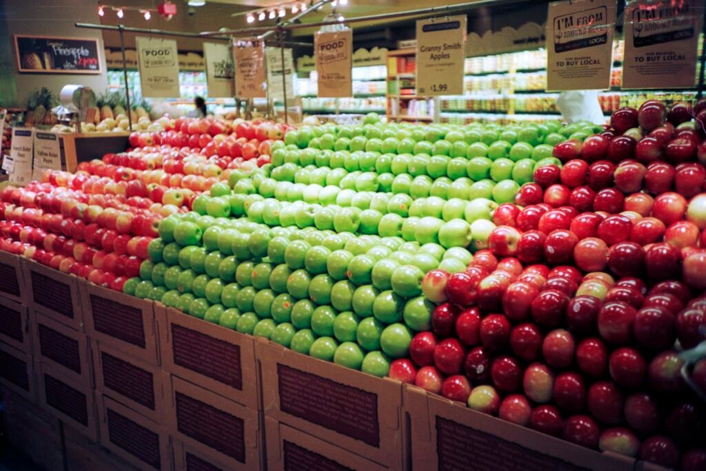 red and green apples on brown wooden crate red and green apples on brown wooden crate