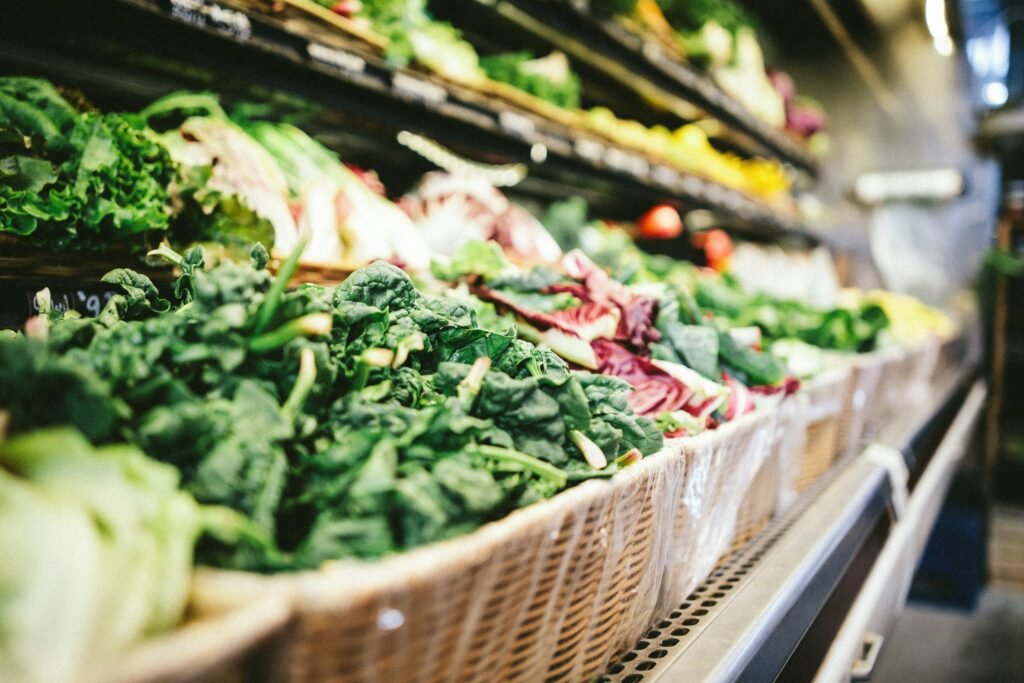 row of vegetables placed on multilayered display fridge row of vegetables placed on multilayered display fridge