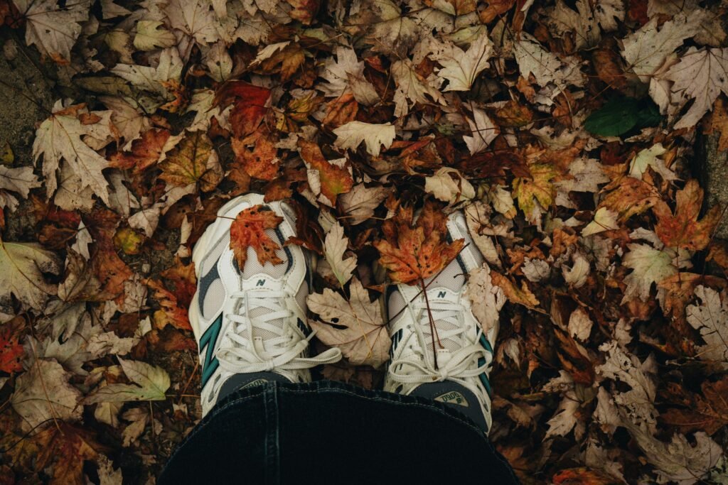 A person standing in a pile of leaves